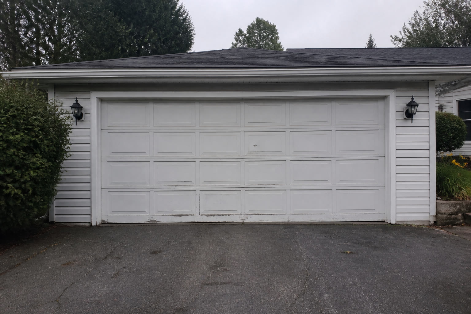 Worn garage door before service
